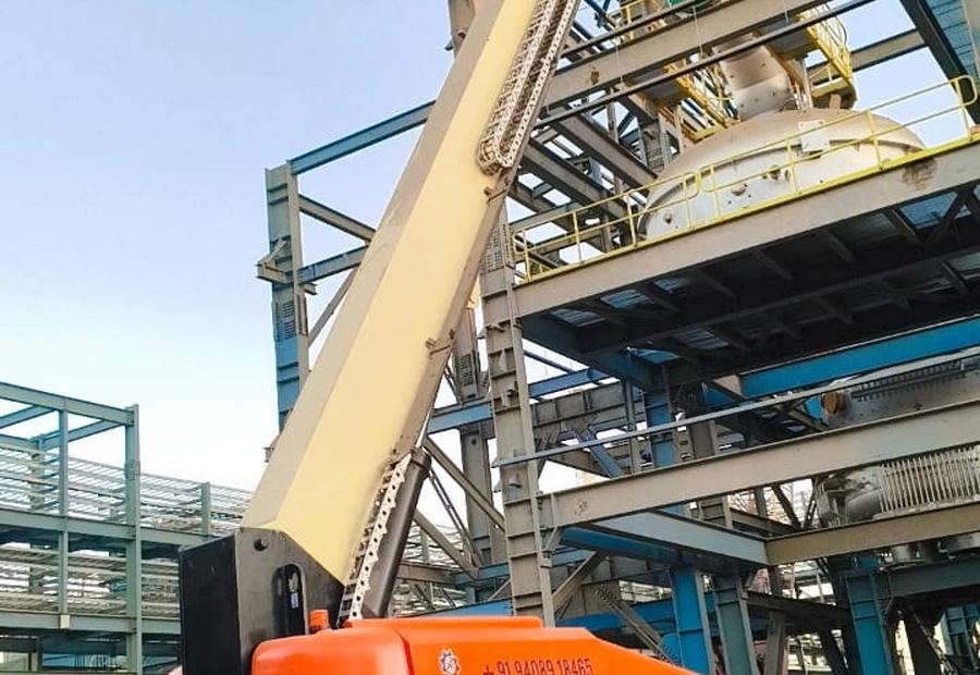 JLG 1200SJP boom lift with boom fully extended providing high level access at a petrochemical structure