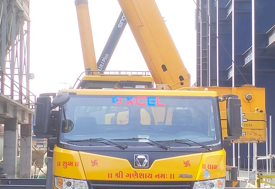 XCMG 70 tonne telescopic truck-mounted crane parked at a construction site in Gujarat